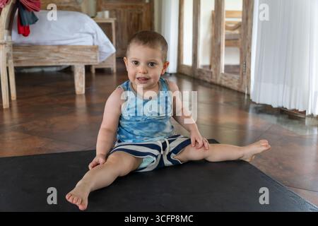 Adorable male toddler plays with his mother not too far away. Stock Photo