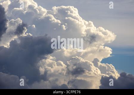 Dramatic afternoon sky with stunning cloud formations. This captivating image features beautiful white and gray clouds floating majestically, creating Stock Photo