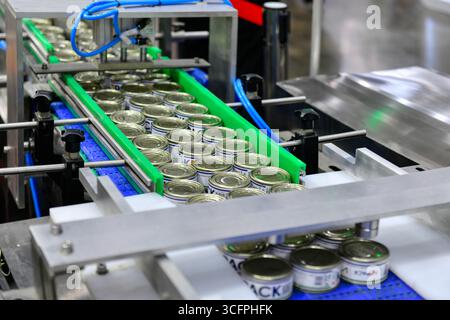 Bangkok, Thailand-June13, 2025: Canned food products on conveyor belt in distribution warehouse.food transportation system concept in Propak asia at B Stock Photo