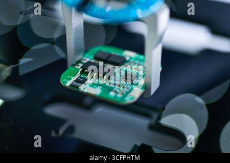 Modern Robot Arm automation system moving circuit boards in a factory ,industrial robot concept Stock Photo