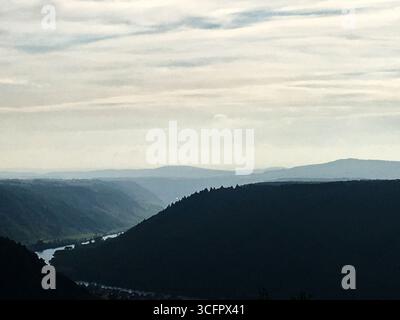 Spectacular view over the mountains, where river Mosel cutting thought the forest landscapes. Calm and dramatic landscape photo of Mosel region Stock Photo
