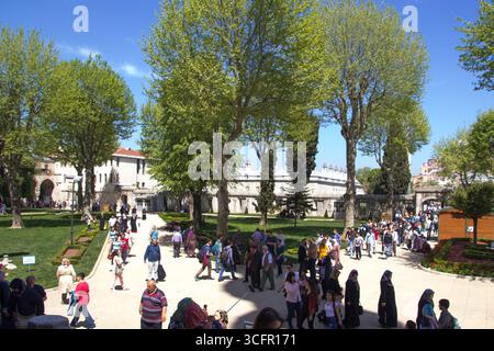 Tourists exploring the historic courtyards of topkapi palace museum in Istanbul Stock Photo