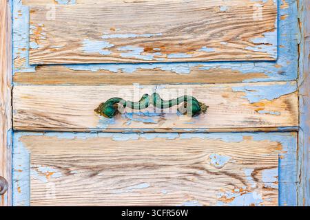 Close-Up of Rustic Antique Door with Blue Paint and Vintage Handle Stock Photo