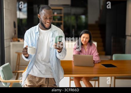Couple of freelance IT specialists using digital technology devices while working remotely from home Stock Photo