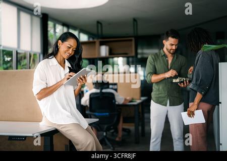 A diverse, talented team collaborates effectively in a bright office space during a business meeting Stock Photo