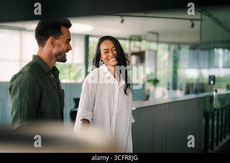 Cheerful diverse coworkers having fun during work break using technology enjoying working together Stock Photo