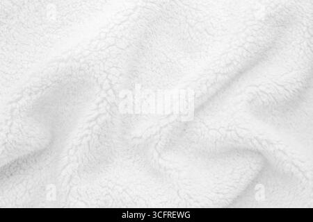 White wavy lambswool texture close up. Warm sheep's wool fabric for blankets. Lining for winter knitted plaid Stock Photo