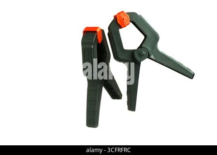 Two black and orange spring clamps on white background Stock Photo