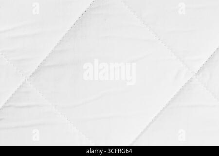 Quilted texture of white fabric for orthopedic mattress Stock Photo