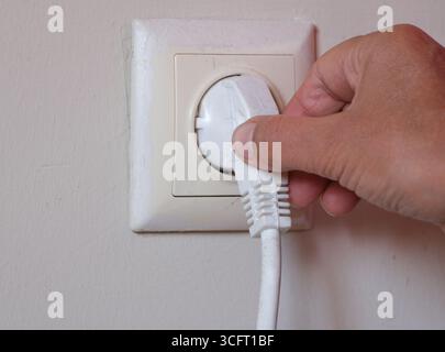 Electrical outlet on a wall. Use of electrical appliances. Stock Photo