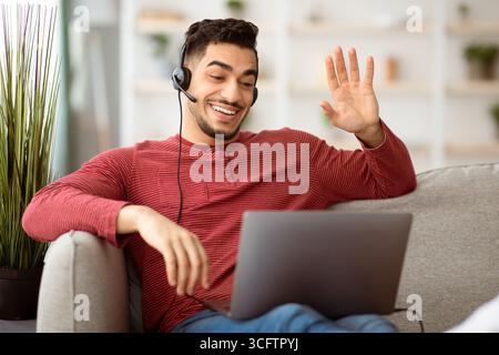 Positive arab guy working from home, having video conference Stock Photo