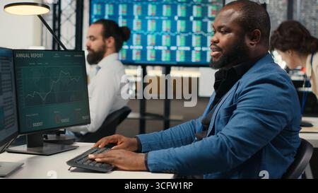 Female colleague bringing documents folders for general manager, assisting the team leader with stack of archived files. Secretary ensuring efficient organizational workflow. Camera B. Stock Photo