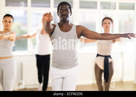African American man practicing ballet movements in choreography studio Stock Photo