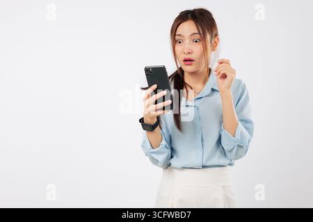 Asian phone woman worry sad surprise unhappy mouth shows shock looking at her mobile in disbelief Stock Photo