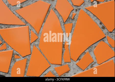 Ceramic tiles mosaic on a wall. Closeup photo of decorative, vintage, artistic tiles creating a geometric pattern. Stock Photo