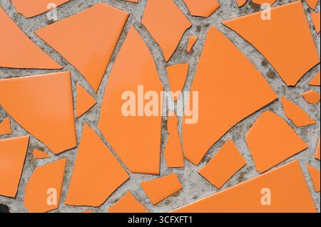 Ceramic tiles mosaic on a wall. Closeup photo of decorative, vintage, artistic tiles creating a geometric pattern. Stock Photo