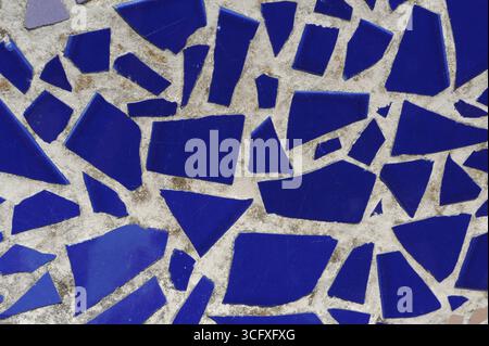 Ceramic tiles mosaic on a wall. Closeup photo of decorative, vintage, artistic tiles creating a geometric pattern. Stock Photo