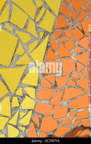 Ceramic tiles mosaic on a wall. Closeup photo of decorative, vintage, artistic tiles creating a geometric pattern. Stock Photo