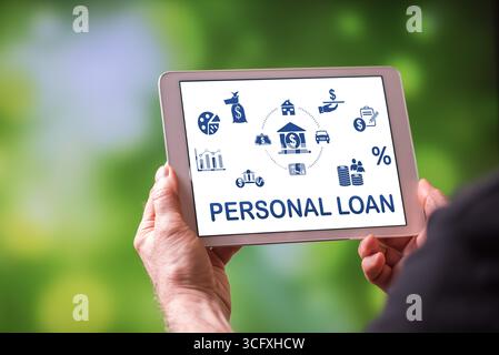 Man holding a tablet showing personal loan concept Stock Photo