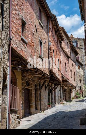 Cortona, Italy - July 6, 2025: Houses in the old medieval town of Cortona Stock Photo