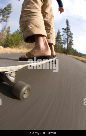 Young man skateboarding near Fallen Leaf Lake, CA. Stock Photo