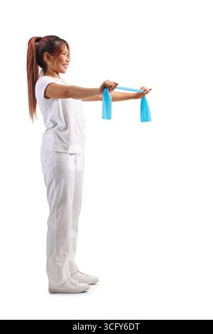 Asian woman in white clothes holding an exercise rubber band isolated on white background Stock Photo