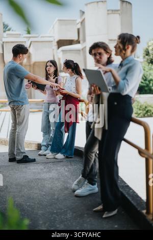 Students and professor discussing outdoors in an academic setting Stock Photo
