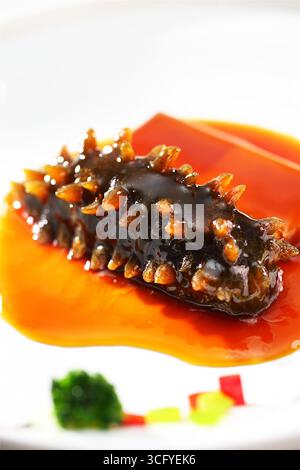 Braised Sea Cucumber with Tofu in Rich Brown Sauce - Close-Up Gourmet Plating Stock Photo