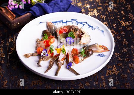 Chinese Rice-Wine Marinated Raw Crab with Edible Flowers Stock Photo