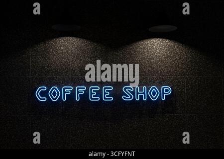 a neon coffee shop sign on the wall illuminated by lamps, web marketing. A business banner. Stock Photo