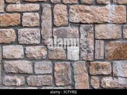 Close-Up of a Rustic Stone Brick Wall with Natural Texture Detail Stock Photo