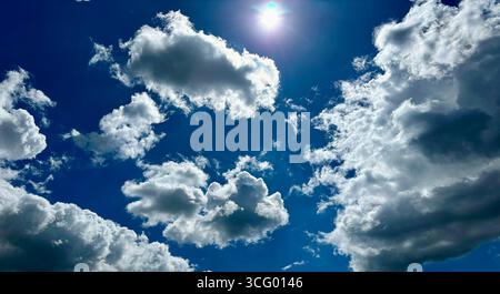 White fluffy clouds against blue sky Stock Photo