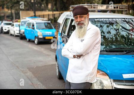 Daily morning scenes from Mumbai Metropola in India, lifestyle of the locals, interesting taxi driver waiting for passengers in city rush hour Stock Photo