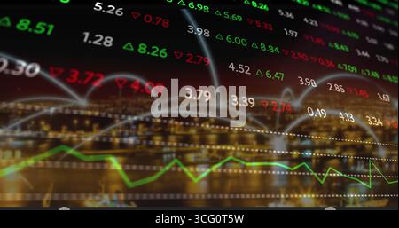 Displaying floating stock numbers, lines, green up and red down triangles on nighttime waterfront Stock Photo