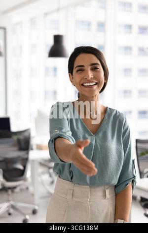 Portrait of friendly Latina businesswoman extending her hand for handshake Stock Photo