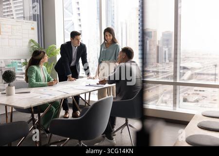 Group of four professionals engaged in srategic business planning meeting Stock Photo