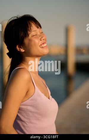Woman nature sunlight enjoying the golden hour while smelling spring ...