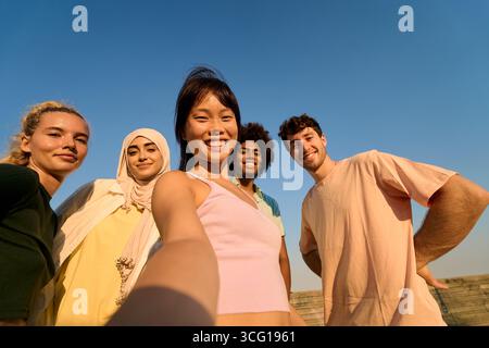 Happy multi ethnic friends taking selfie outdoors in summer day Stock Photo