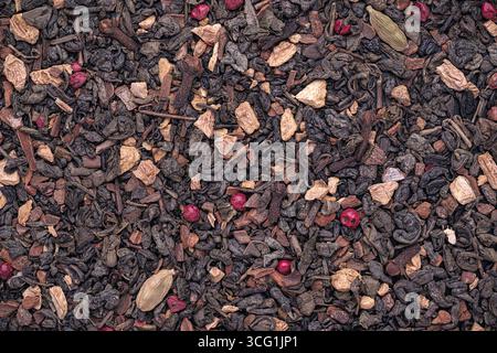 Top view of dried Green tea, Ginger, Cinnamon, Pink peppercorn, Cardamom, clove - Chai Tea Stock Photo