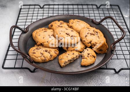 Freshly baked Chocolate chip cookies in steel tray. grey background. top view. Stock Photo