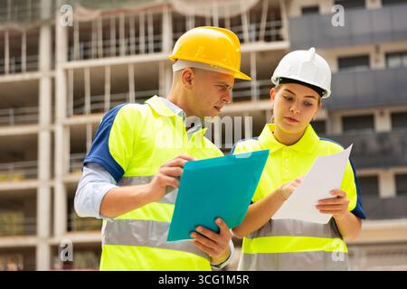 Two qualified engineers are discussing a construction plan Stock Photo