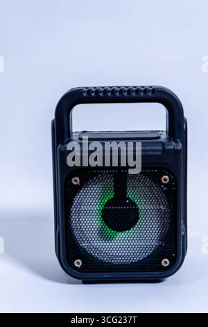 Portable speaker with integrated handle and green light showing, isolated on a white background Stock Photo