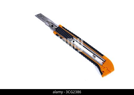 Studio shot of an orange and black utility knife resting on a white background Stock Photo