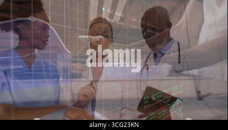 Reviewing medical data nurse and doctors collaborating at hospital using display wall and tablet Stock Photo
