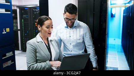 Server room, team and people with laptop for software, diagnostics or discussion. IT, technician and planning with computer in datacenter for Stock Photo