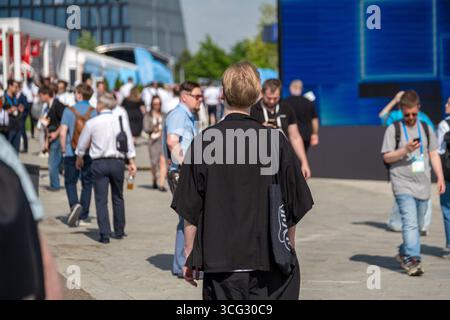 Conference attendees networking during an outdoor event on a bright sunny day Stock Photo