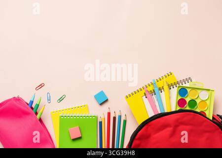 Back to school. School backpack, pencil case with different stationery on colored background. Flat lay with copy space. Stock Photo