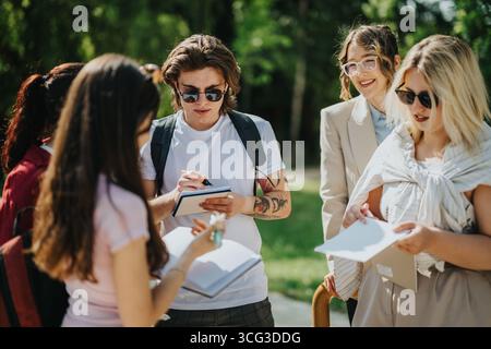 Students engaging in an outdoor educational activity with their teacher Stock Photo