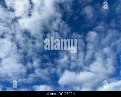 Beautiful blue sky filled with fluffy white clouds. Stock Photo
