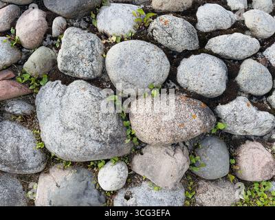 Surface composed of various smooth, rounded stones. Stock Photo